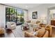 Comfortable living room featuring stylish furniture, large windows, and hardwood floors overlooking the outdoor space at 214 Vickery Falls Dr, Roswell, GA 30075