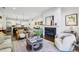 Spacious living room featuring hardwood floors, a fireplace, and an open layout connecting to the kitchen at 214 Vickery Falls Dr, Roswell, GA 30075