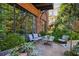 Inviting brick patio with comfortable seating amidst lush greenery, perfect for relaxing at 214 Vickery Falls Dr, Roswell, GA 30075