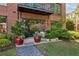Charming patio with brick facade, lush landscaping, and comfortable outdoor seating at 214 Vickery Falls Dr, Roswell, GA 30075