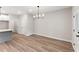 Spacious dining area with hardwood floors and modern light fixture at 4655 Larkfield Way, Powder Springs, GA 30127