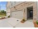 Townhome with attached garage, manicured front yard, and neutral brick at 4655 Larkfield Way, Powder Springs, GA 30127