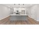 Modern kitchen with an island, white cabinets, stainless steel appliances, and wood floor at 4655 Larkfield Way, Powder Springs, GA 30127