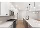 Modern kitchen with white cabinets, an island with a sink, and pendant lighting at 4655 Larkfield Way, Powder Springs, GA 30127