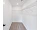 Empty walk-in closet with wire shelving and neutral carpet at 4655 Larkfield Way, Powder Springs, GA 30127
