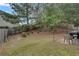 Spacious backyard with lush green grass, mature trees, and a fence line at 5437 Blossom Brook Dr, Sugar Hill, GA 30518
