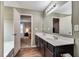 Bathroom with a double sink vanity, dark wood cabinets, and view of the main bedroom at 5437 Blossom Brook Dr, Sugar Hill, GA 30518
