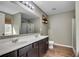 Bathroom features a dual sink vanity with dark wood cabinets and a large mirror at 5437 Blossom Brook Dr, Sugar Hill, GA 30518