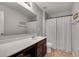 Neutral bathroom featuring a single sink vanity with decorative hardware and a shower-tub combination at 5437 Blossom Brook Dr, Sugar Hill, GA 30518