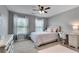Bedroom with carpet, a ceiling fan, desk, and natural light from two windows at 5437 Blossom Brook Dr, Sugar Hill, GA 30518