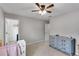 Comfortable bedroom featuring soft carpet, a ceiling fan, and soft blue dresser at 5437 Blossom Brook Dr, Sugar Hill, GA 30518