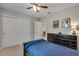 Comfortable bedroom featuring a ceiling fan, a bed, a large dresser and a large closet at 5437 Blossom Brook Dr, Sugar Hill, GA 30518