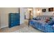 Bedroom with a blue dresser, stylish decor, and a bed with a colorful patterned comforter at 5437 Blossom Brook Dr, Sugar Hill, GA 30518