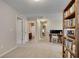 Spacious bonus room with neutral carpet and adjacent bathroom and potential desk area at 5437 Blossom Brook Dr, Sugar Hill, GA 30518