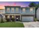 Charming two-story home features a two-car garage, manicured lawn and is beautifully landscaped at 5437 Blossom Brook Dr, Sugar Hill, GA 30518