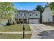 Charming two-story home with a well-manicured lawn and attached two car garage at 5437 Blossom Brook Dr, Sugar Hill, GA 30518