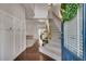 Inviting foyer with hardwood floors, board and batten trim, and stairway leading to the upper level at 5437 Blossom Brook Dr, Sugar Hill, GA 30518