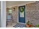 Charming brick home featuring a welcoming blue front door adorned with a decorative wreath at 5437 Blossom Brook Dr, Sugar Hill, GA 30518