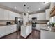 Bright kitchen features white cabinetry, granite countertops, stainless steel appliances and hardwood flooring at 5437 Blossom Brook Dr, Sugar Hill, GA 30518