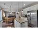 Open concept kitchen featuring stainless appliances, granite countertops, a center island, and an adjacent dining area at 5437 Blossom Brook Dr, Sugar Hill, GA 30518