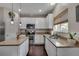 Well-lit kitchen featuring a center island with granite countertop, stainless steel appliances, and ample storage space at 5437 Blossom Brook Dr, Sugar Hill, GA 30518