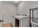 Bright laundry room with a new washer, dryer, and wire shelving for storage at 5437 Blossom Brook Dr, Sugar Hill, GA 30518