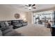 Open-concept living room featuring a leather sectional, adjacent to kitchen and dining area, creating an inviting atmosphere at 5437 Blossom Brook Dr, Sugar Hill, GA 30518