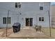 Back patio with a grill, outdoor seating, and overhead string lights at 5437 Blossom Brook Dr, Sugar Hill, GA 30518