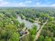 Aerial view of a scenic lake neighborhood with beautiful homes surrounded by trees and lush greenery at 1190 Hess Dr, Avondale Estates, GA 30002