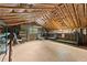 Unfinished attic space with exposed wood beams, insulation, and shelving, offering potential for storage or conversion at 1190 Hess Dr, Avondale Estates, GA 30002
