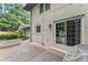 Backyard patio area featuring white brick home with sliding glass doors, brick planter and barbecue at 1190 Hess Dr, Avondale Estates, GA 30002