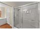 A glass-enclosed shower with tile surround and bathroom vanity at 1190 Hess Dr, Avondale Estates, GA 30002