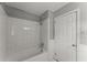 Bathroom with bathtub, shower, tiled walls and a white door at 1190 Hess Dr, Avondale Estates, GA 30002