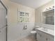A well-lit bathroom with wainscoting, ceramic tile floors, and a window at 1190 Hess Dr, Avondale Estates, GA 30002