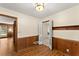 Spare bedroom featuring wood paneling and flooring with access to other rooms in the house at 1190 Hess Dr, Avondale Estates, GA 30002