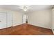 Bedroom with hardwood floors, closet, ceiling fan, and light paint at 1190 Hess Dr, Avondale Estates, GA 30002
