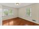 A well-lit bedroom features two windows, hardwood floors, and light-colored walls at 1190 Hess Dr, Avondale Estates, GA 30002