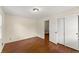 Bedroom with a large closet, hardwood floors and a view into the hallway at 1190 Hess Dr, Avondale Estates, GA 30002