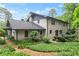 Two-story home with brick exterior, landscaped backyard, brick chimney, and covered patio at 1190 Hess Dr, Avondale Estates, GA 30002