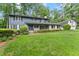 Two-story home with green lawn and mature trees at 1190 Hess Dr, Avondale Estates, GA 30002