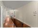 Hallway with wooden railing and hardwood floors at 1190 Hess Dr, Avondale Estates, GA 30002
