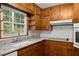 The kitchen features granite countertops, a subway tile backsplash, wood cabinets, and stainless steel appliances at 1190 Hess Dr, Avondale Estates, GA 30002