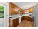 Classic kitchen with wood cabinets, granite countertops, stainless steel appliances, and a view of the backyard at 1190 Hess Dr, Avondale Estates, GA 30002