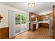 Warm kitchen featuring wooden cabinets, stainless steel appliances, granite countertops, and a sliding glass door at 1190 Hess Dr, Avondale Estates, GA 30002