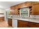 Well-lit kitchen featuring wood cabinets, subway tile backsplash, granite countertops, and an undermount sink at 1190 Hess Dr, Avondale Estates, GA 30002