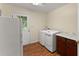 Functional laundry room with modern washer and dryer, laminate floors at 1190 Hess Dr, Avondale Estates, GA 30002