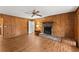 Cozy living room with wood paneling, fireplace, and laminate floors at 1190 Hess Dr, Avondale Estates, GA 30002