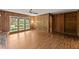 Bright room featuring wood paneling, ceiling fan, and large windows at 1190 Hess Dr, Avondale Estates, GA 30002