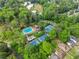 Amazing aerial view of community pool and tennis courts surrounded by trees creating a fun neighborhood destination at 1190 Hess Dr, Avondale Estates, GA 30002