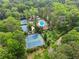 Overhead view of community amenities with swimming pool and tennis courts surrounded by lush greenery at 1190 Hess Dr, Avondale Estates, GA 30002